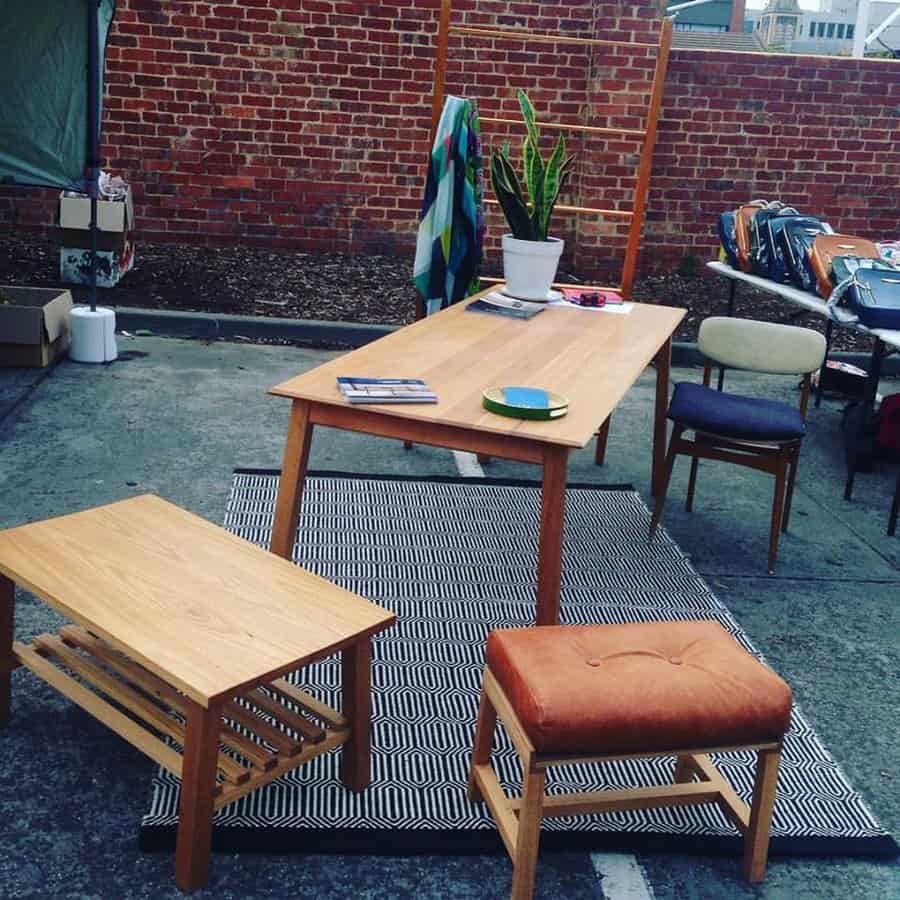Outdoor market atmosphere at Brunswick Flea Market on Dawson Street Melbourne with shoppers and stalls