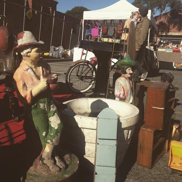 Shoppers browsing retro collectibles and vinyl records at the Brunswick Flea Market next to Howler