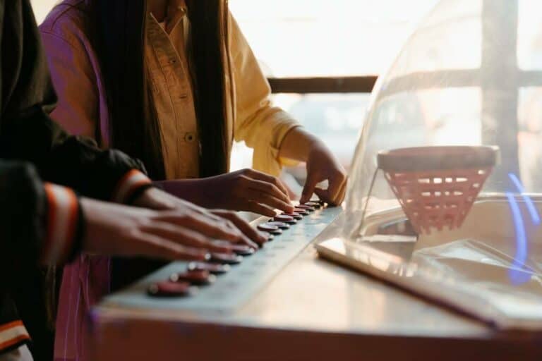 two kids playing an electronic keyboard together